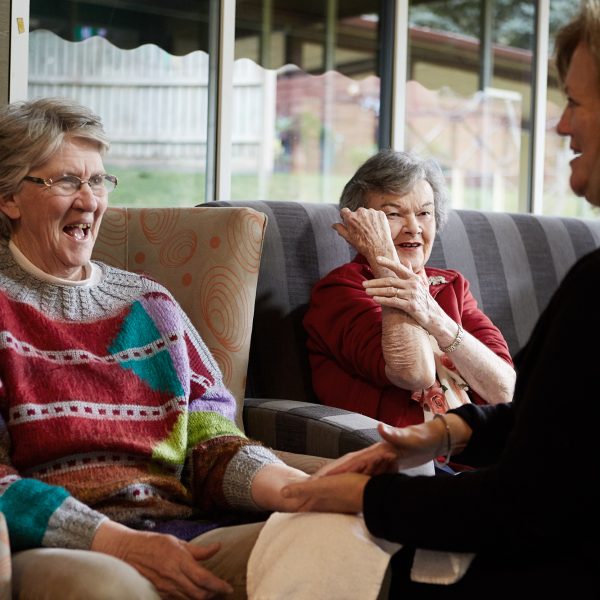 Two residents enjoying a hand therapy session with the physiotherapist